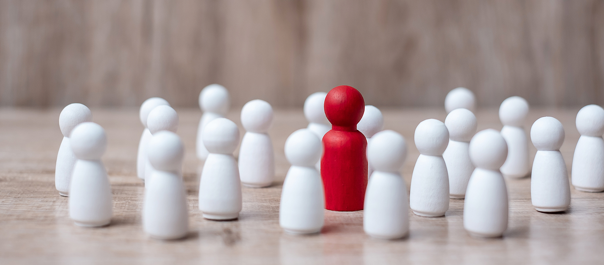 white wooden figures, one is red