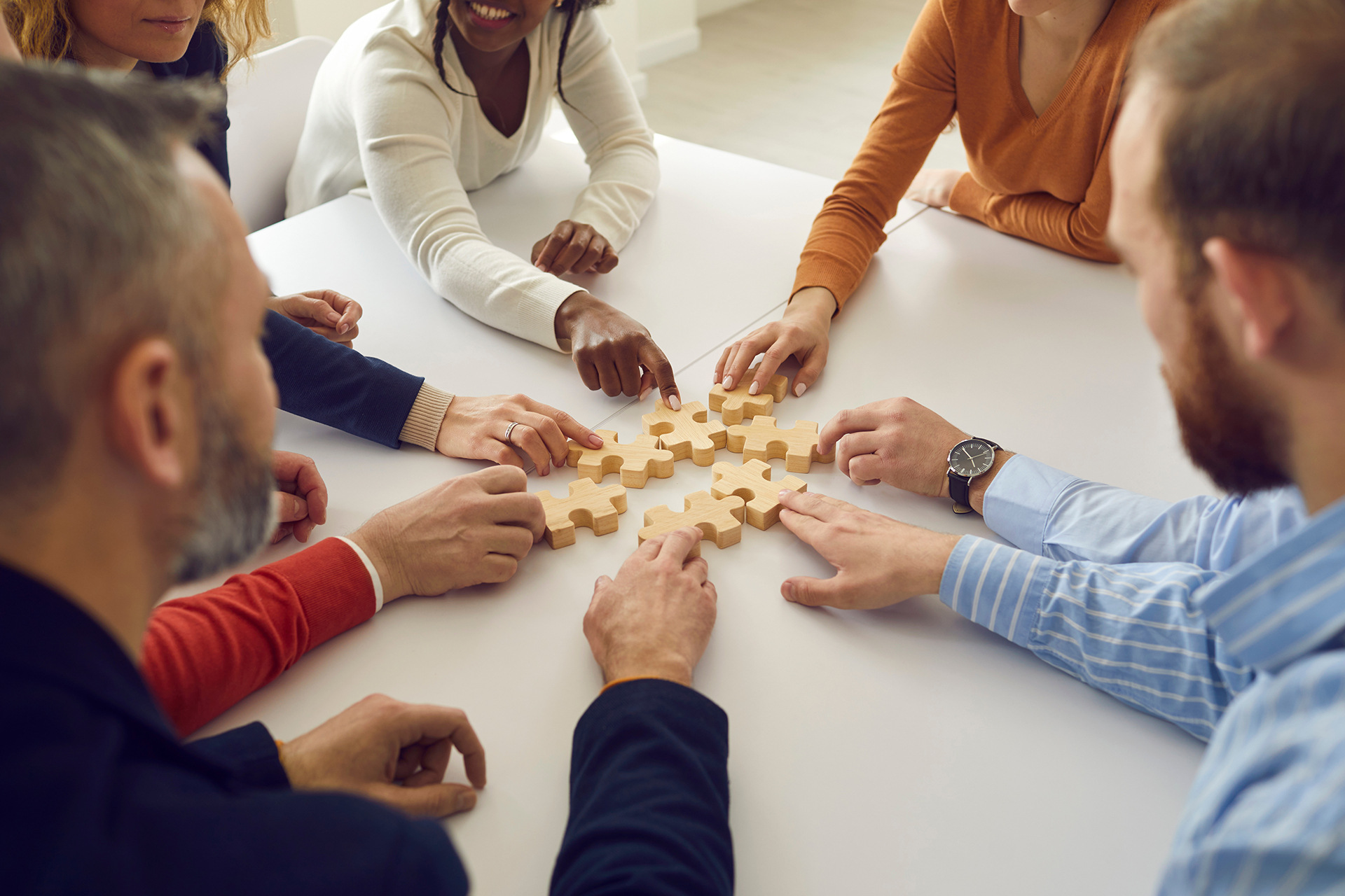 Team placing puzzle pieces together