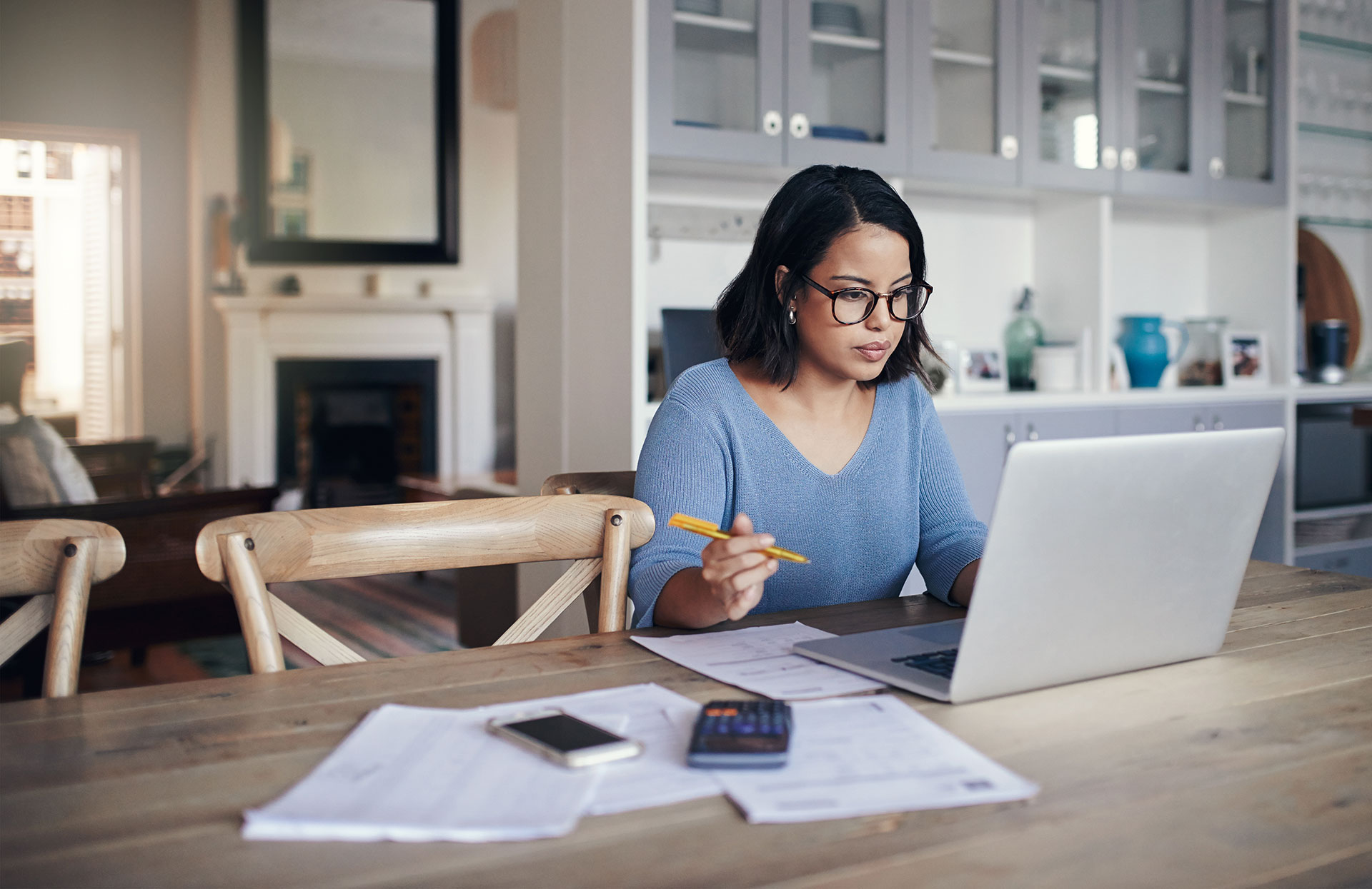 Woman sitting at a table with a calculator