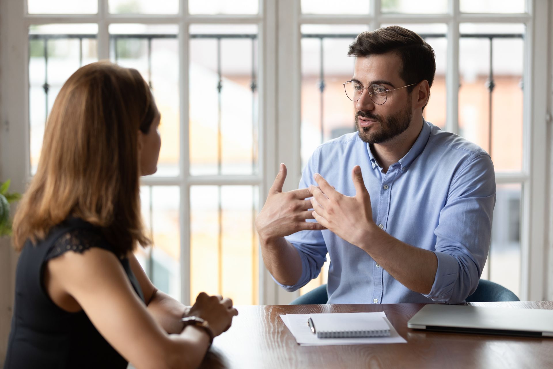 Two people talking at a table