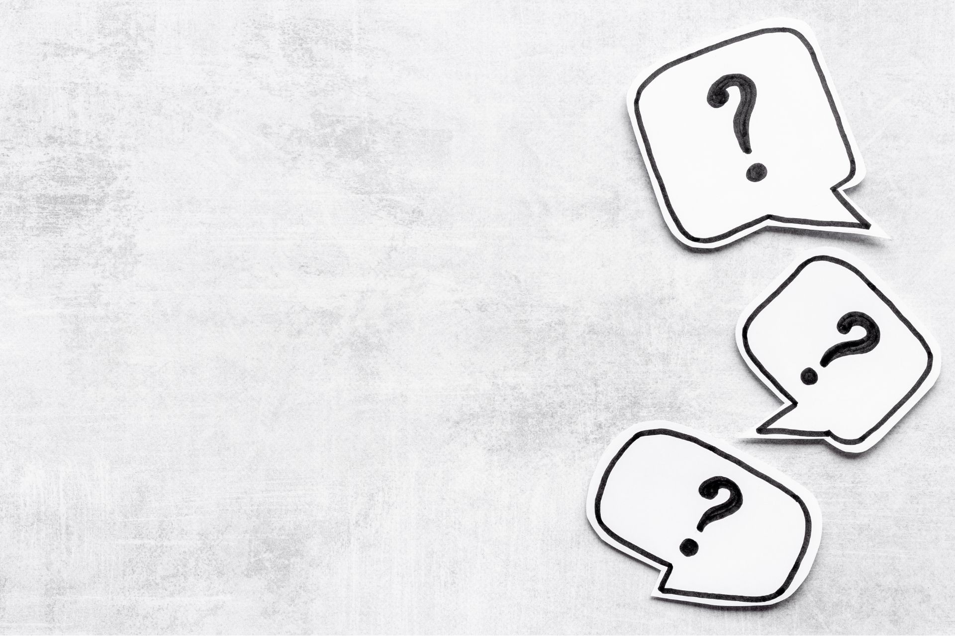 white background with speech bubbles containing question marks